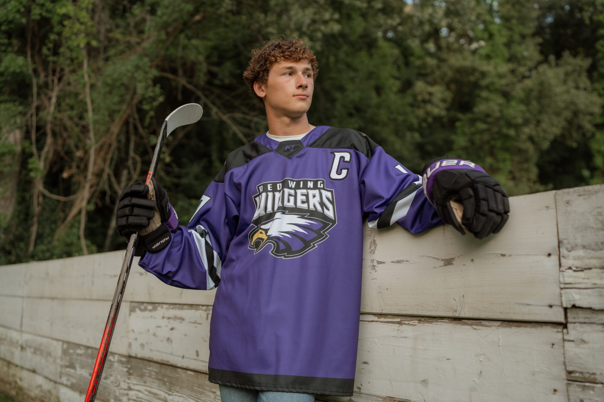 guy wearing hockey jersey and holding his stick for Minnesota senior phtoos