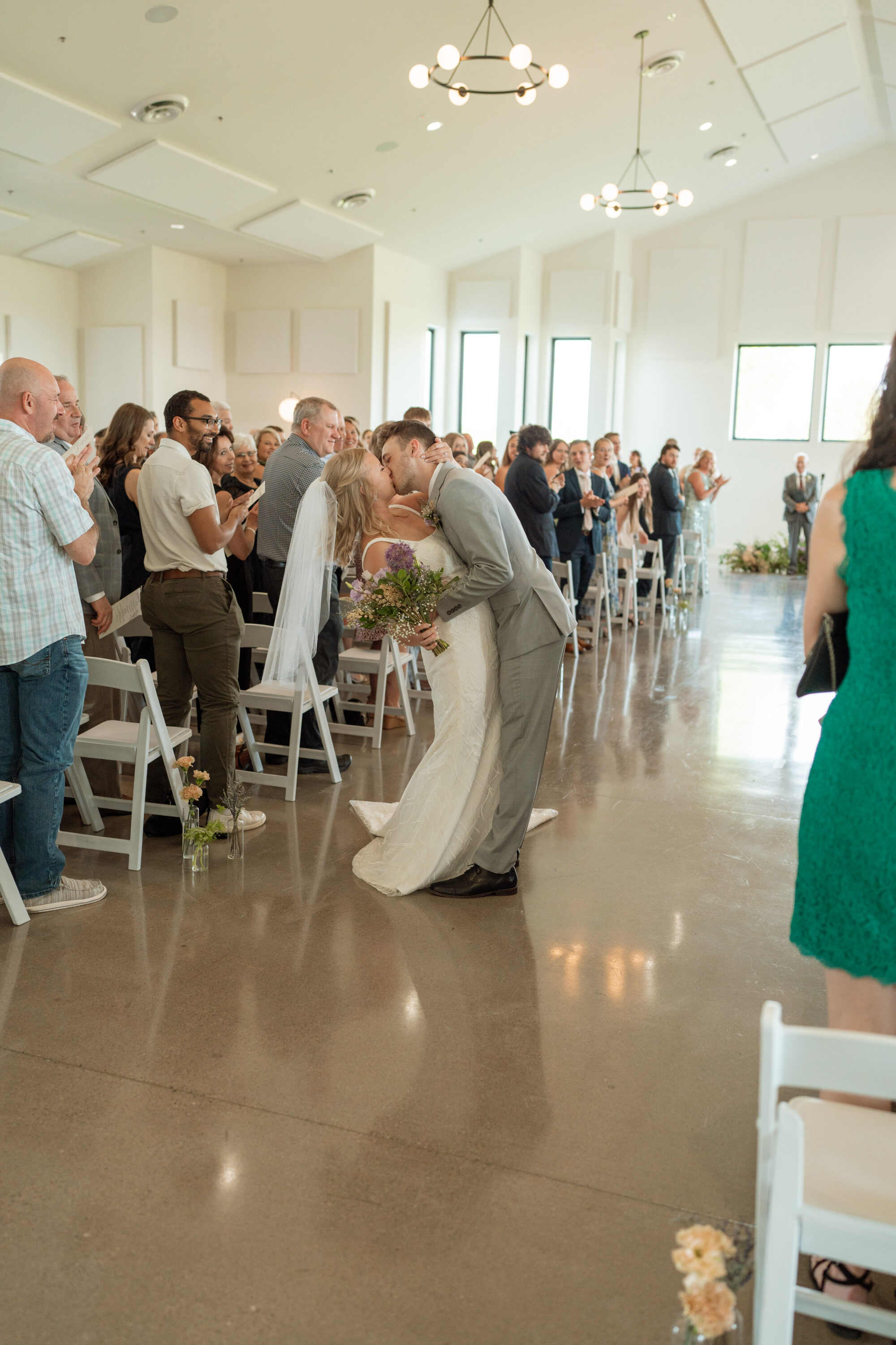 Couple kissing at the end of the aisle after there ceremony at Minnesota wedding venue Woodhaven Wedding & Events in Cannon Falls in Minnesota.