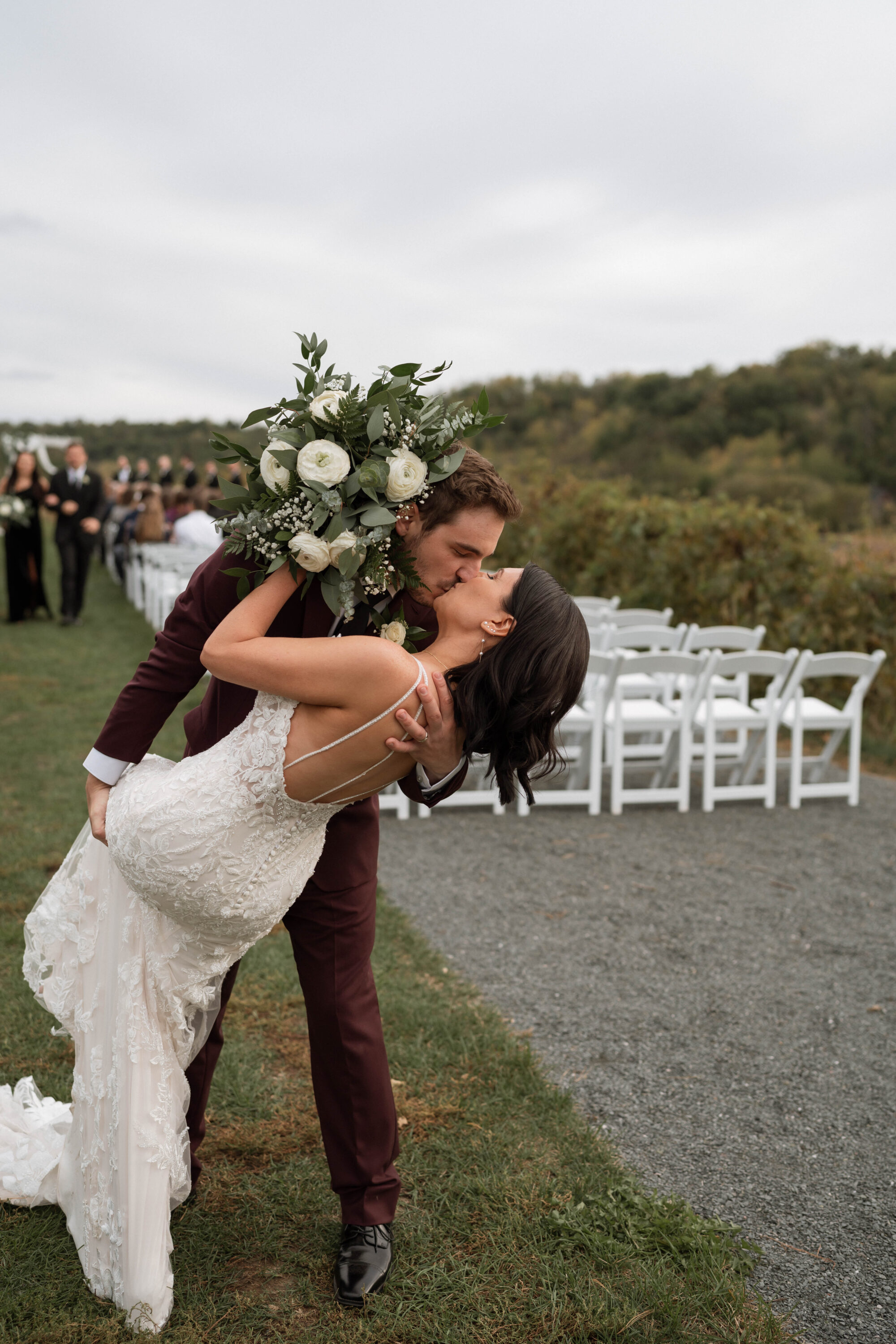 Couple kissing at the end of the aisle at the end of their ceremony a wedding set at Willow Brooke Farm, in Red Wing, MN. 