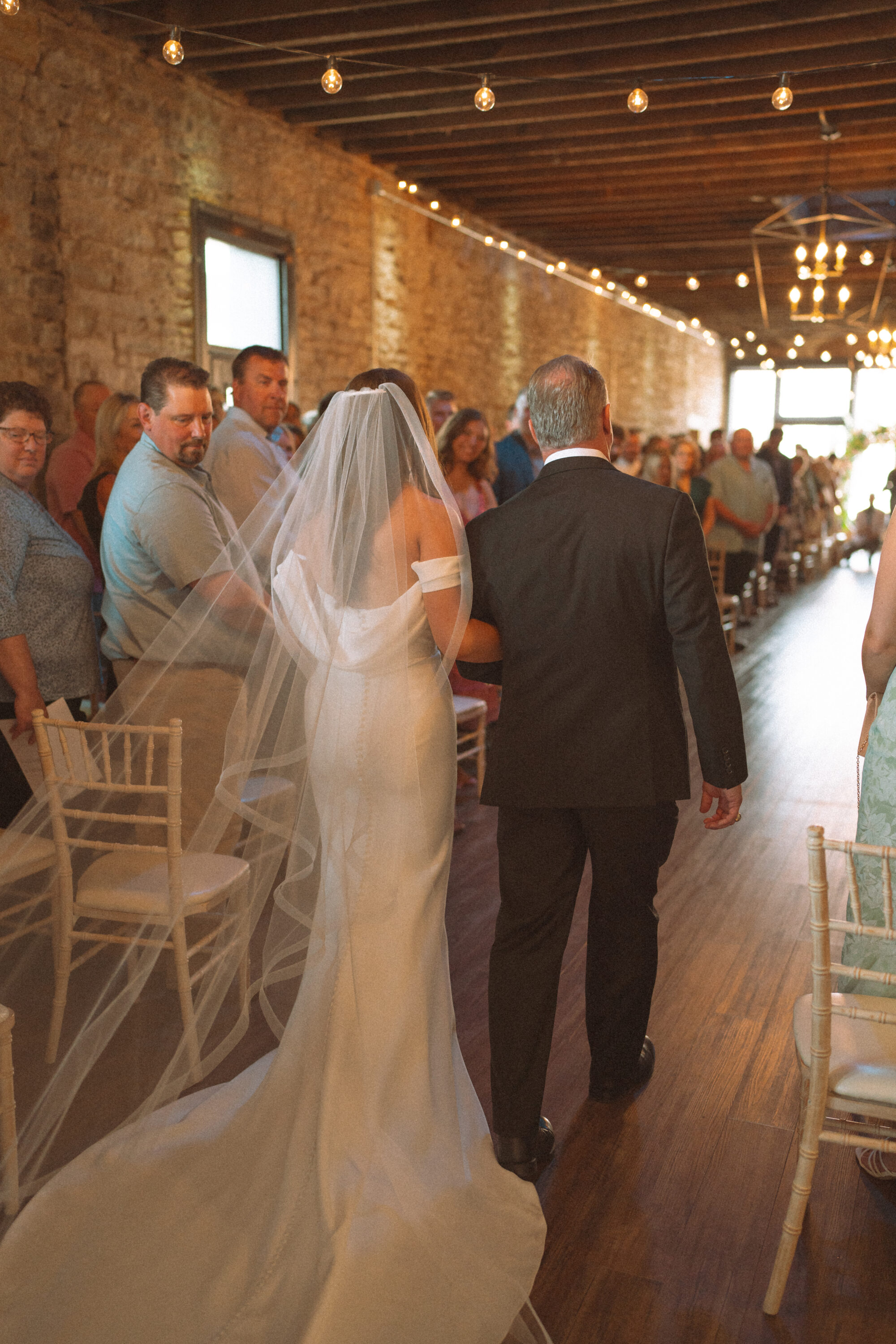 Bride and her father walking down the aisle during ceremony at the 3 Ten Event Venue in Faribault, MN.