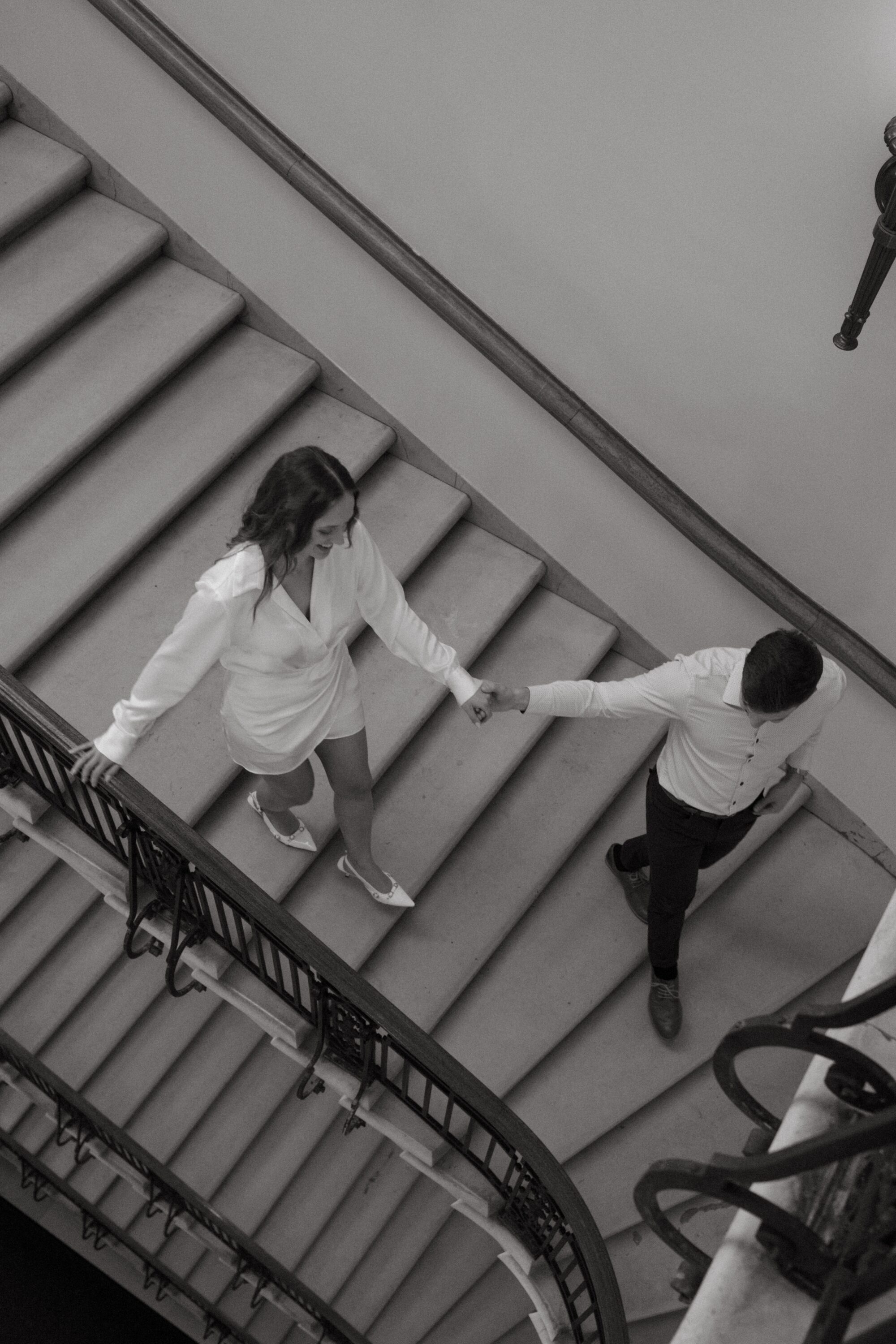 engaged couple walkling on the stairs at the mn state capitol