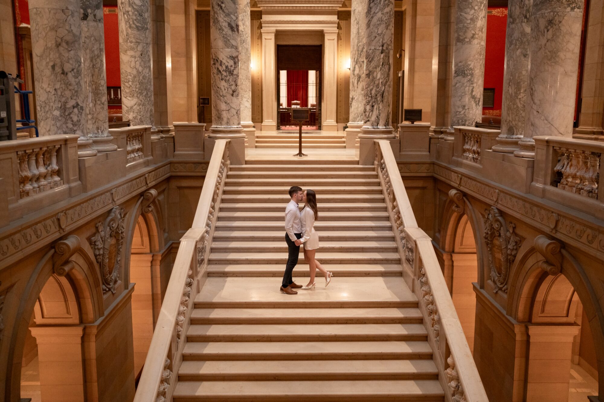 couple kissing on grand staircase at minnesota state capitol building