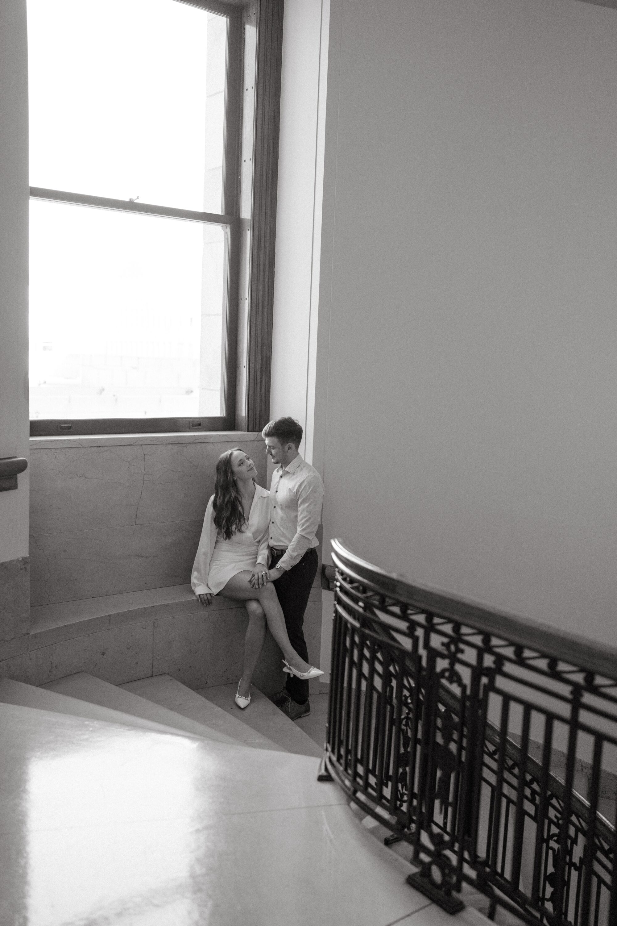 Pulled back shot of engaged couple at the Minnesota State Capitol building